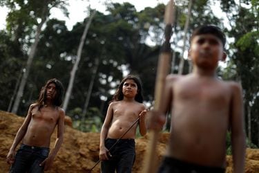 Indigenous people from the Mura tribe react in front of a deforested in unmarked indigenous lands inside the Amazon rainforest near Humaita