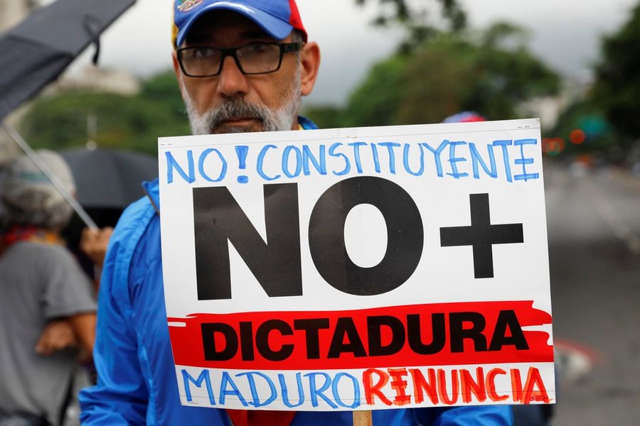An opposition supporter holds a placard during a protest against Venezuela's President Nicolas Maduro's government in Caracas