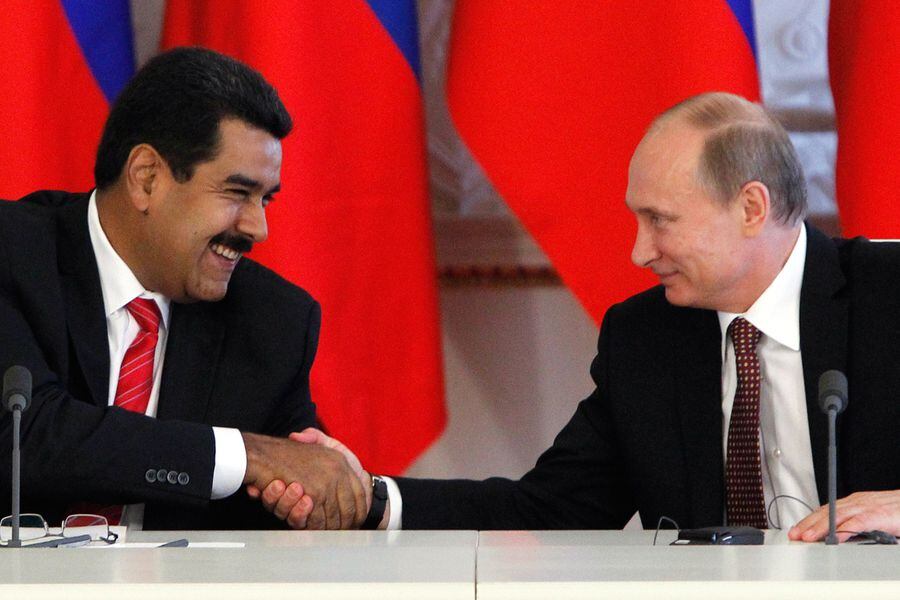 Russian President Vladimir Putin shakes hands with his Venezuelan counterpart Nicolas Maduro during a signing ceremony at the Kremlin in Moscow