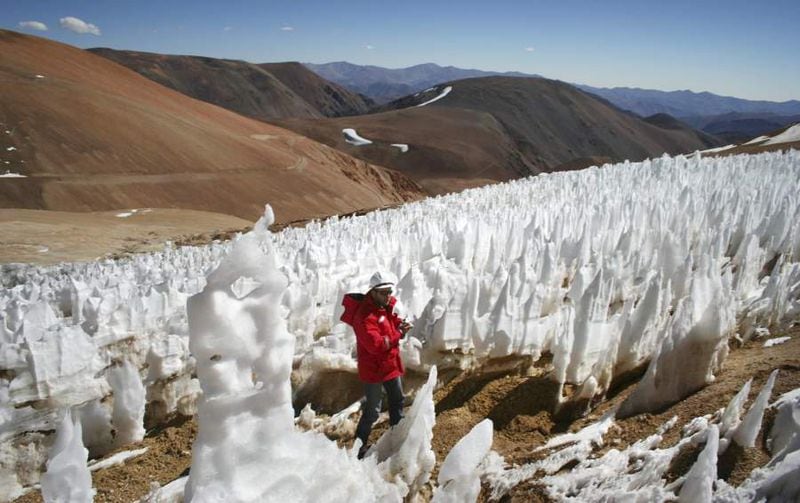File picture of man walking by El Toro II glacier on the Chilean side of the border district between Chile's Huasco province and Argentina's San Juan province next to Pascua Lama gold project