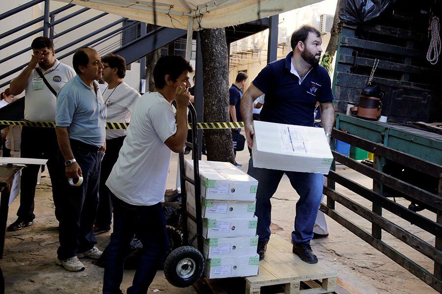 Electoral workers transport materials for the upcoming presidential election of April 22 at the Superior Court of Electoral Justice in Asuncion