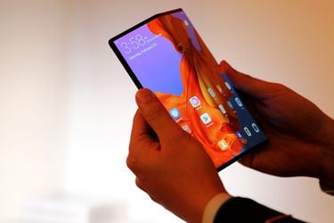 A member of Huawei staff shows the new Huawei Mate X device during a pre-briefing display ahead of the Mobile World Congress in Barcelona