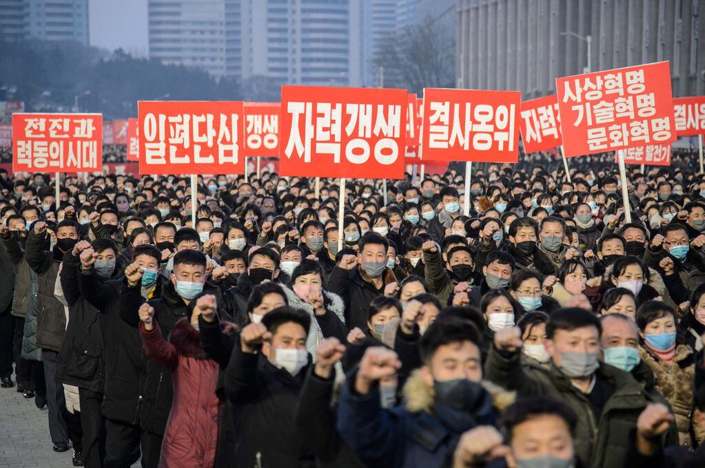 In this picture taken on January 5, 2022, people take part in a demonstration march after the Pyongyang City rally to carry out the decision of the 4th Plenary Meeting of the 8th Central Committee of the Workers' Party of Korea, at Kim Il Sung Square in Pyongyang. (Photo by KIM Won Jin / AFP)