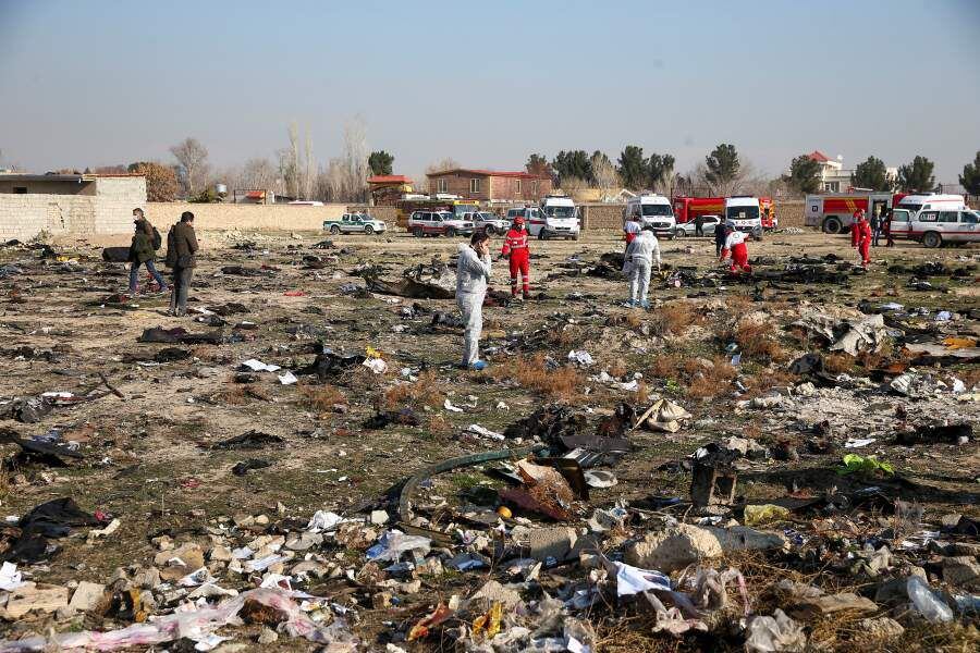 Rescue team works among debris of a plane belonging to Ukraine International Airlines, that crashed after take-off from Iran's Imam Khomeini airport, on the outskirts of Tehran