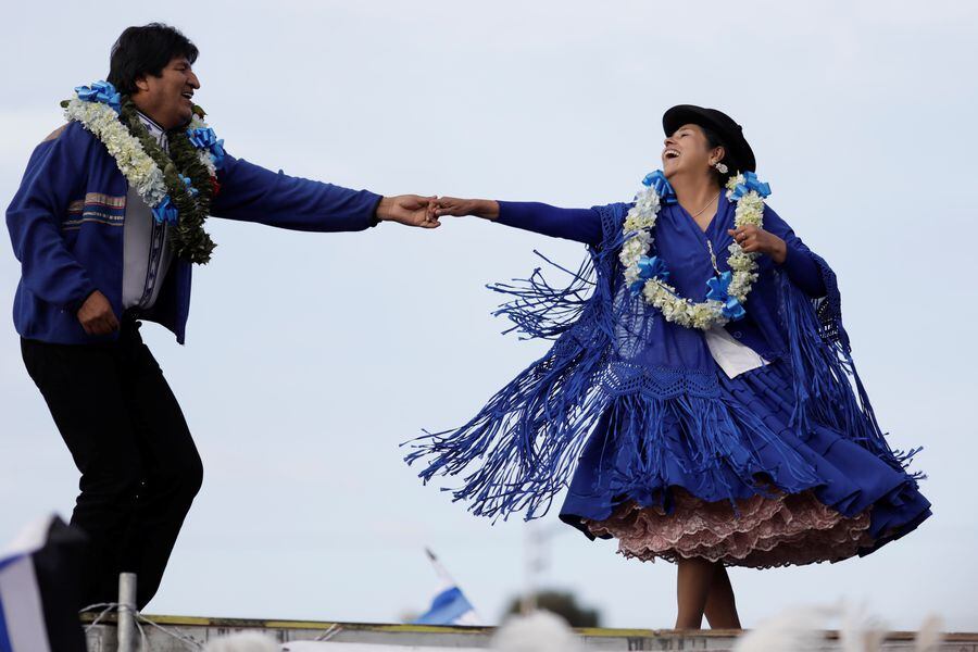 Bolivia's President and current presidential candidate for the Movement for Socialism (MAS) party Evo Morales dances during a closing campaign rally in El Alto