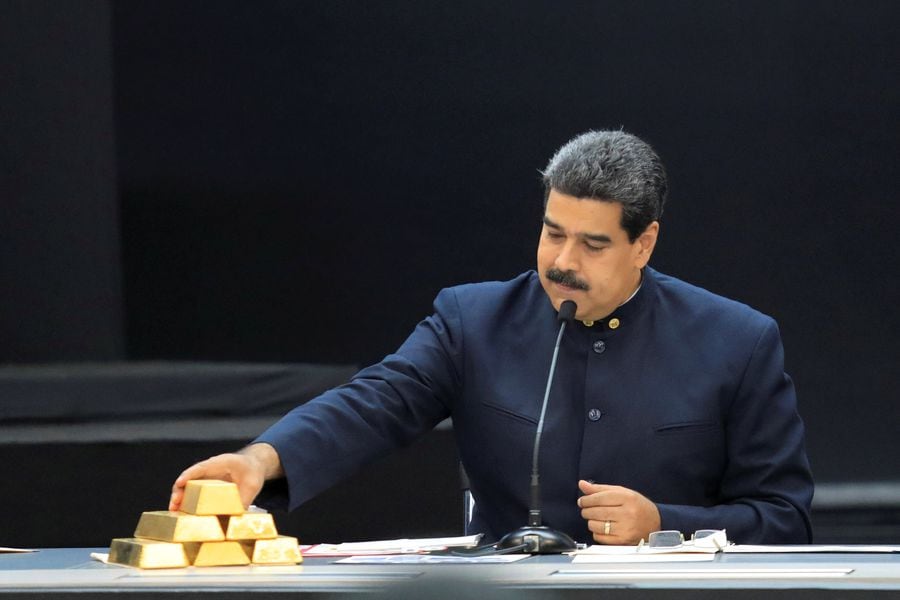 FILE PHOTO: Venezuela's President Maduro touches a gold bar as he speaks during a meeting with the ministers responsible for the economic sector in Caracas