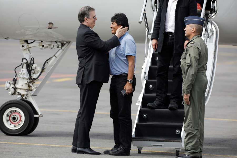 Bolivia's ousted President Evo Morales is welcomed by Mexico's Foreign Minister Marcelo Ebrard during his arrival to take asylum in Mexico, in Mexico City