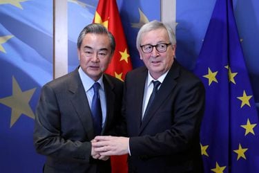FILE PHOTO: Chinese Foreign Minister Wang Yi is welcomed by European Commission President Jean-Claude Juncker ahead of a meeting in Brussels