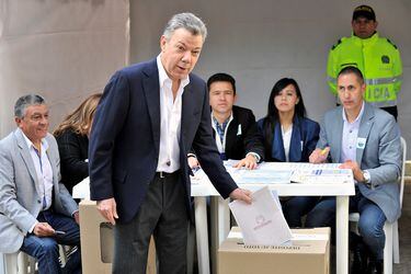 Colombia's President Juan Manuel Santos casts his vote during the legislative elections in Bogota