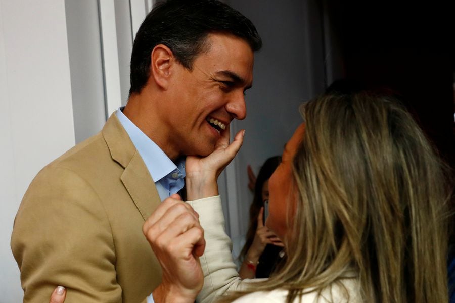 Spain's acting Prime Minister Pedro Sanchez is congratulated before a party meeting a day after Spain's general election, at PSOE headquarters in Madrid