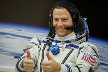 FILE PHOTO: The International Space Station (ISS) crew member Nick Hague of the U.S. gestures after donning space suits shortly before launch at the Baikonur Cosmodrome