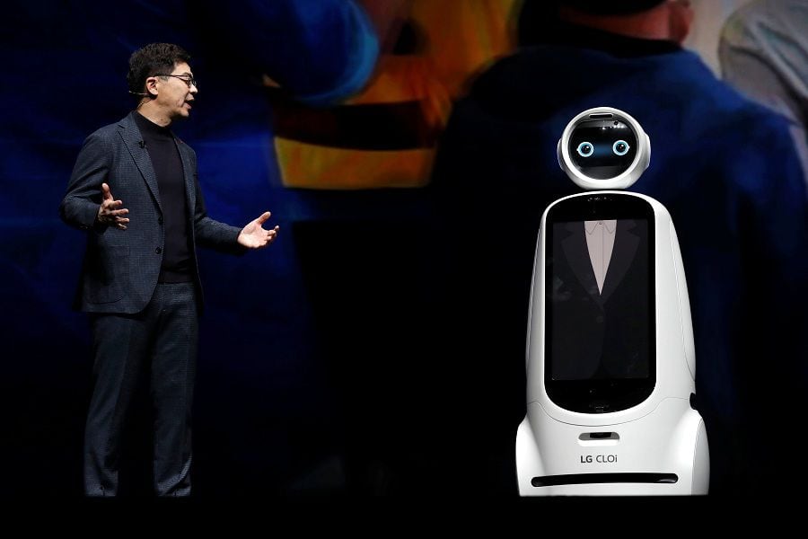 I.P. Park, president and chief technical officer for LG Electronics, speaks with a LG Cloi robot during a keynote address at the 2019 CES in Las Vegas
