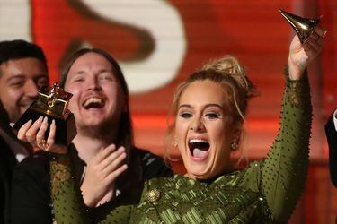 Adele breaks the Grammy for Record of the Year for "Hello" after having it presented to her at the 59th Annual Grammy Awards in Los Angeles
