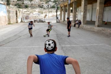 Dvir Gelman (12) le pasa la pelota a un compañero durante un partido con otros niños judíos en un asentamiento en Hebrón, ciudad que tanto hebreos como musulmanes consideran santa.