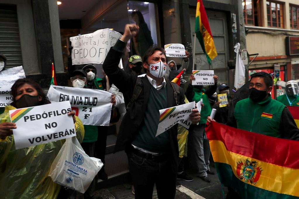Opponents of Bolivia's former President Evo Morales protest outside the Court of Justice building in La Paz, Bolivia, Monday, Sept. 7, 2020. Former President Morales was disqualified by the court to run for senator for the department of Cochabamba during the upcoming general elections on Oct. 18. (AP Photo/Juan Karita)