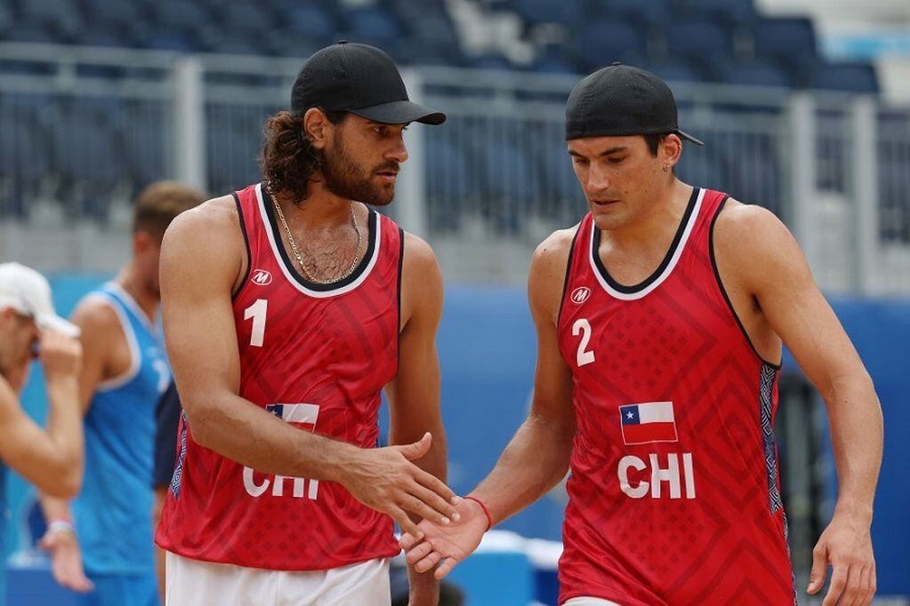 TOKYO, JAPAN - AUGUST 02: Marco Grimalt #1 of Team Chile and Esteban Grimalt #2 react after the play against Team ROC during the Men's Round of 16 beach volleyball on day ten of the Tokyo 2020 Olympic Games at Shiokaze Park on August 02, 2021 in Tokyo, Japan. (Photo by Sean M. Haffey/Getty Images)