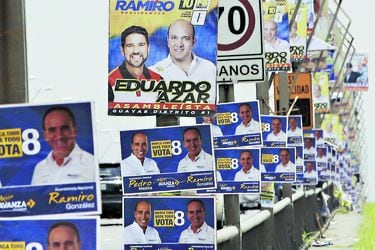Propaganda of Ecuadorean presidential candidates hangs from lighting