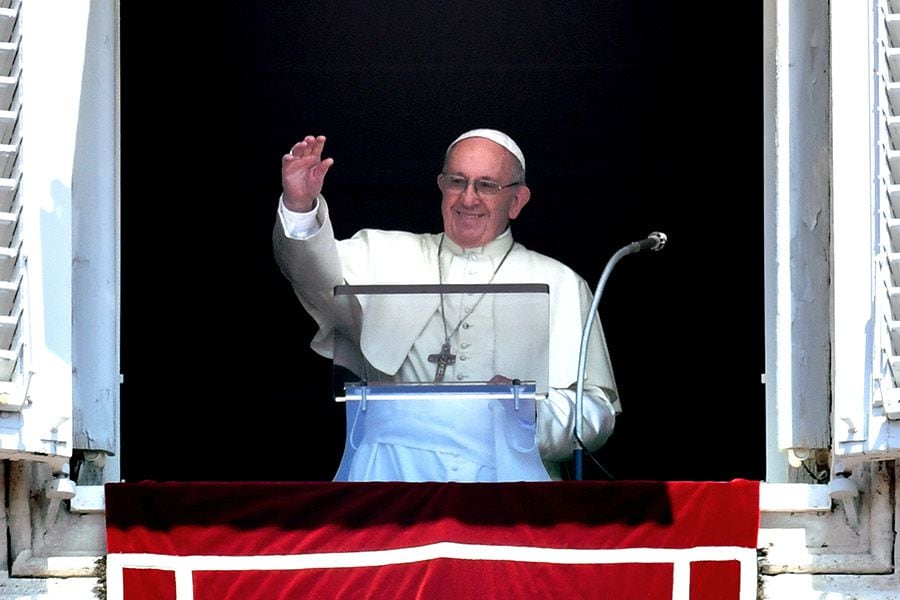 Pope Francis waves to the crowd from the window of the Apostolic Pala