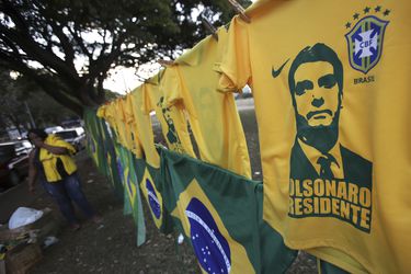 A woman sells T-shirts and flags with the image of presidential front