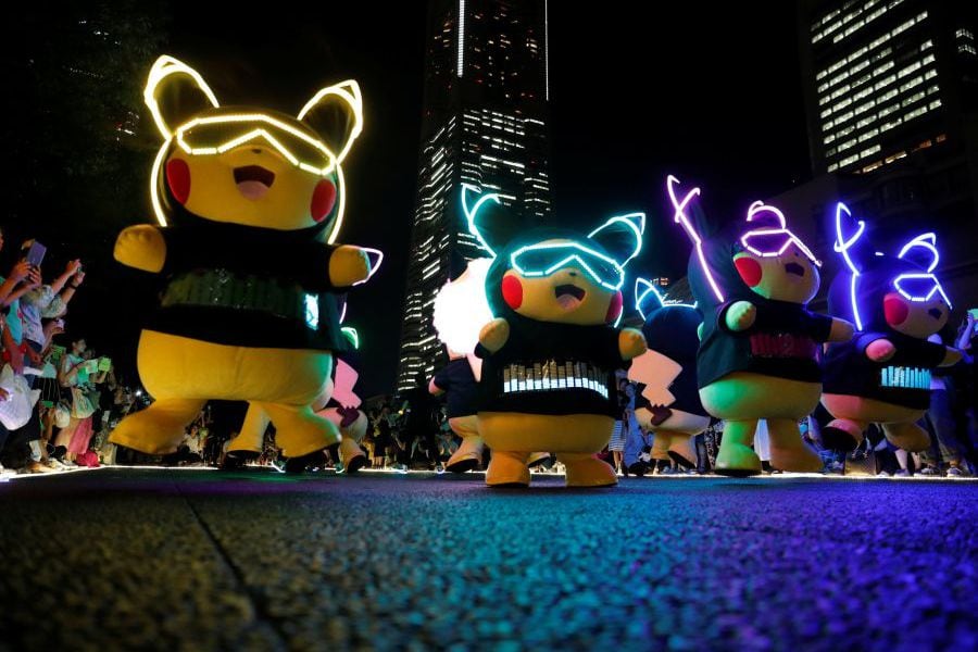 Performers wearing Pokemon's character Pikachu costumes take part in a night parade in Yokohama