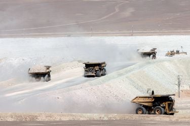 FILE PHOTO - Trucks travel along a road at Escondida, the world's biggest copper mine, in Antofagasta,