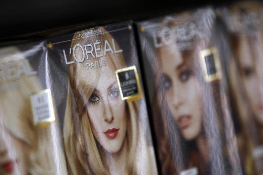 Boxes of L'Oreal hair dyes, produced by L'Oreal SA, sit displayed for sale inside a supermarket in London, U.K., on Tuesday, Feb. 11, 2014. The pound rose to a one-week high against the dollar after an industry report showed U.K. retail sales growth accelerated in January, adding to evidence the recovery is gaining momentum. Photographer: Simon Dawson/Bloomberg