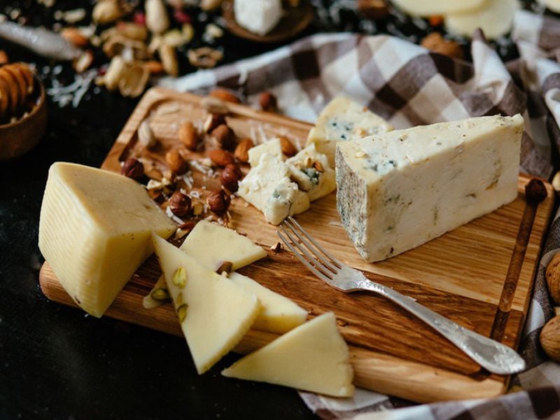 Cheeseboard. Delicious blue cheese on the board. Blue cheese Gorgonzola with nuts