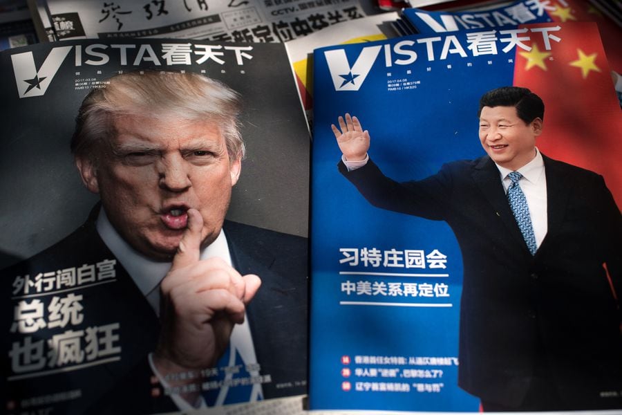 Magazines featuring front pages of US President Donald Trump (L) and