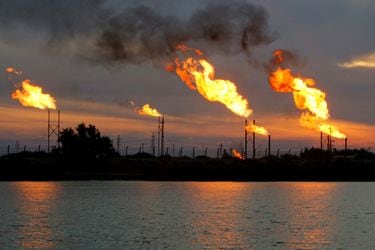 FILE PHOTO: Flames emerge from flare stacks at the oil fields in Basra