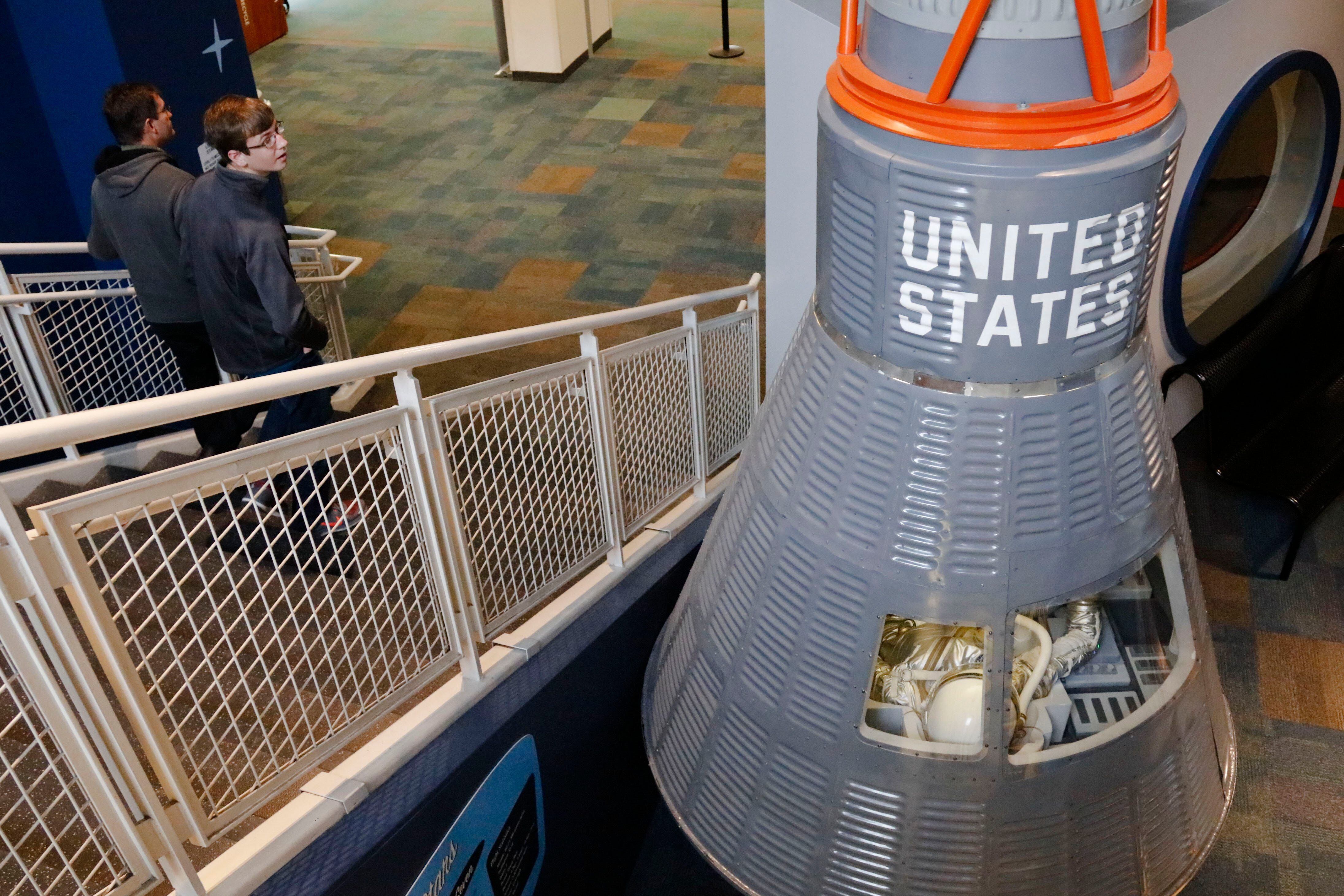 Benjamin Gingerich, 14, of West Jefferson, looks back at a replica of the Friendship 7 spacecraft as part of an exhibit on