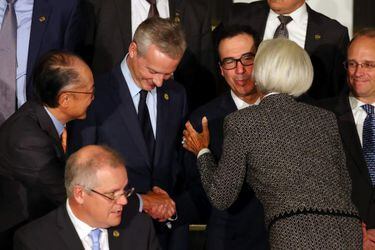 U.S. Secretary of the Treasury Mnuchin kisses IMF Managing Director Lagarde and shakes hands with World Bank president Kim as they arrive for the official photo at the G20 Meeting of Finance Ministers in Buenos Aires