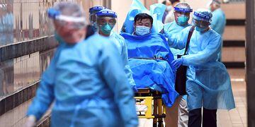 Medical staff transfer a patient of a highly suspected case of a new coronavirus at the Queen Elizabeth Hospital in Hong Kong