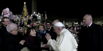 Pope Francis slaps the hand of a woman who grabbed him, at Saint Peter's Square at the Vatican