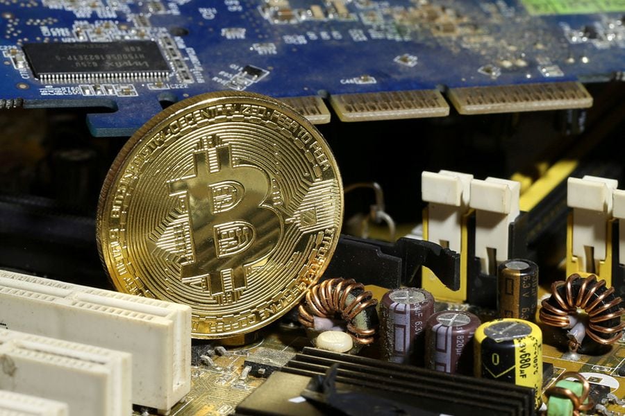 FILE PHOTO: A copy of bitcoin standing on PC motherboard is seen in this illustration picture