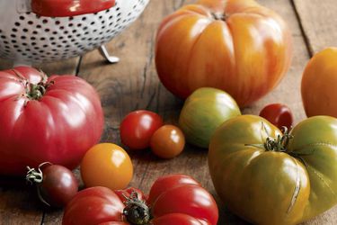 Variety of heirloom tomatoes on wood surface