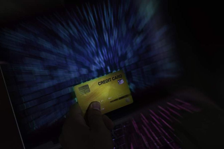 Man hand on check credit card with laptop, shopping online concept, Dangers of using credit cards in e-commerce businesses