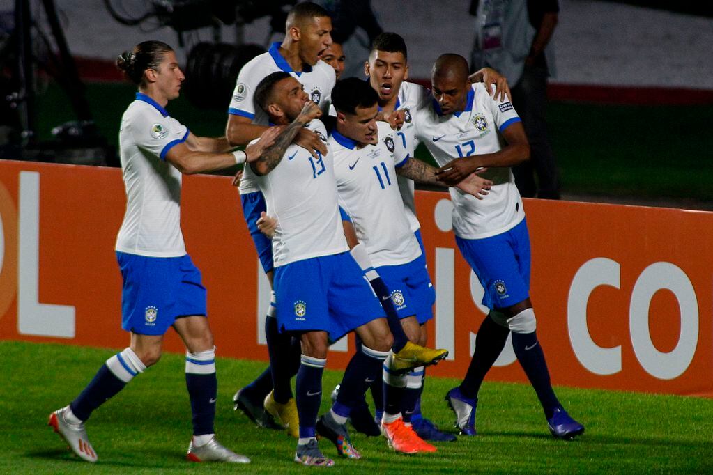 Brazil's Philippe Coutinho (11) celebrates with teammates after scoring against Bolivia during their Copa America football tournament group match at the Cicero Pompeu de Toledo Stadium, also known as Morumbi, in Sao Paulo, Brazil, on June 14, 2019. / A...
