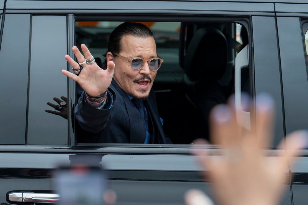 FILE - Actor Johnny Depp waves to supporters as he departs the Fairfax County Courthouse after closing arguments on May 27, 2022 in Fairfax, Va.  Heard says she doesn’t blame the jury that awarded Johnny Depp more than $10 million after a contentious six-week libel trial in her first post-verdict interview. She told Savannah Guthrie of “Today” in a clip aired Monday that she understood how the jury reached its conclusion and said Depp is a “beloved character and people feel they know him.” (AP Photo/Craig Hudson, File)