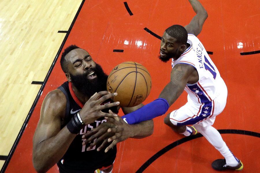 Houston Rockets' James Harden (13) is fouled by Philadelphia 76ers' J