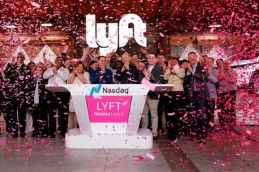 Lyft President John Zimmer and CEO Logan Green applaud as Lyft lists on the Nasdaq at an IPO event in Los Angeles