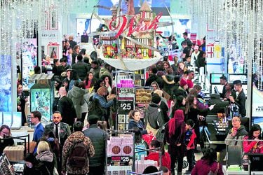 FILE PHOTO: People shop in Macy's Herald Square during early opening for the Black Friday sales in Manhattan