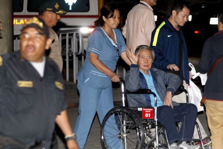 Former Peruvian President Alberto Fujimori accompanied by his son Kenji Fujimori leaves the Centenario hospital in Lima
