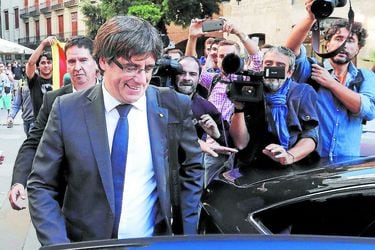 Catalan President Puigdemont leaves the regional government headquarters after delivering a statement in Barcelona