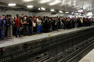 Commuters wait to board a metro at the Gare du Nord subway station during a strike by all unions of the Paris transport network (RATP) against pension reform plans in Paris