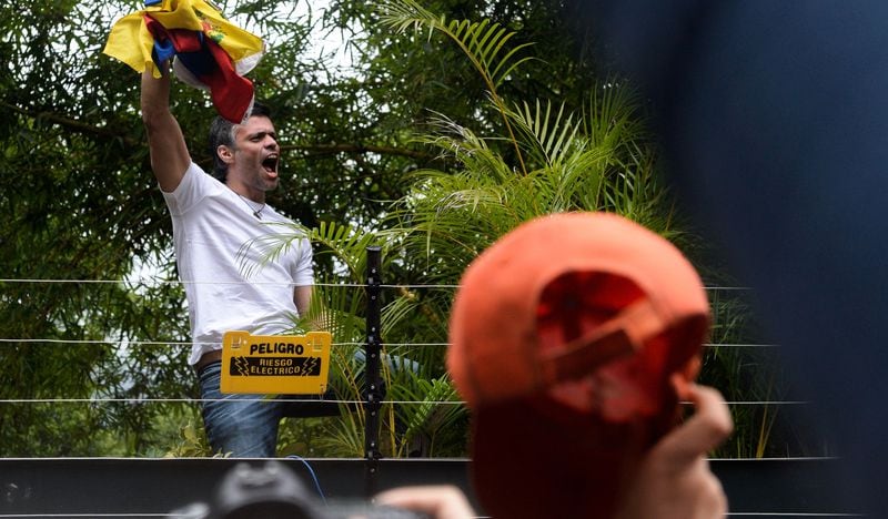 Venezuelan opposition leader Leopoldo Lopez displays a Venezuelan nat