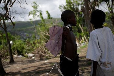 Children chat in the yard of a temporary shelter after Hurricane Matthew hit Jeremie, Haiti
