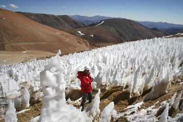 File picture of man walking by El Toro II glacier on the Chilean side of the border district between Chile's Huasco province and Argentina's San Juan province next to Pascua Lama gold project