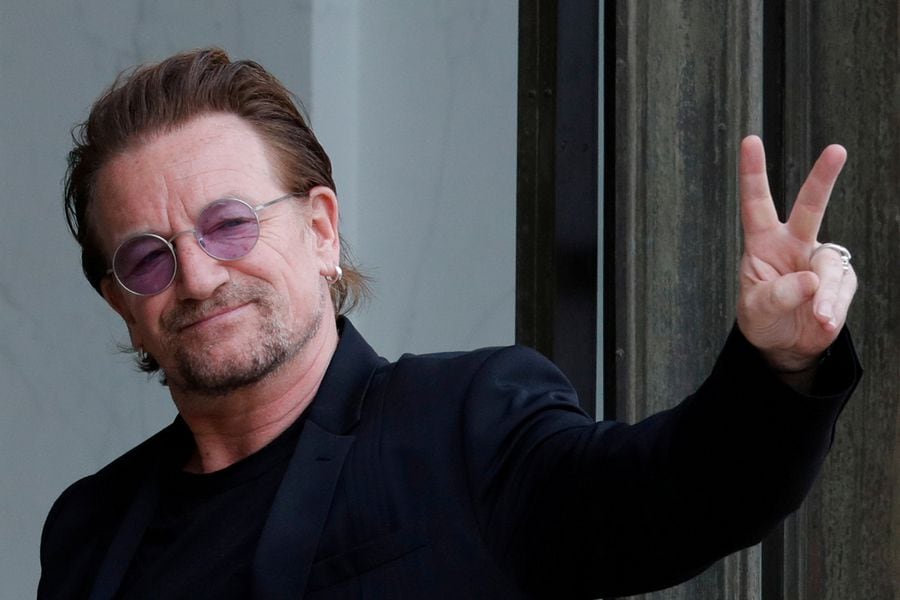 FILE PHOTO: Singer Bono of Irish band U2 and co-founder of ONE organization waves as he arrives at the Elysee Palace in Paris