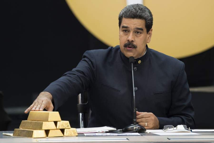 Nicolas Maduro, Venezuela's president touch a pile of 12 Kilogram gold ingots during a press conference on 'Petro' cryptocurrency in Caracas, Venezuela, on Thursday, March 22, 2018. U.S. President Trump banned U.S. purchases of 'Petro' cryptocurrency as part of a campaign to pressure the government of President Nicolas Maduro. Photographer: Carlos Becerra/Bloomberg