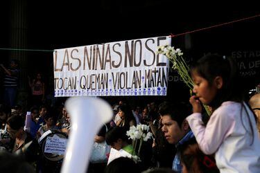 People take part in a protest to demand justice for the victims of a fire at the Virgen de Asuncion children's shelter, in front of the National Palace in Guatemala City